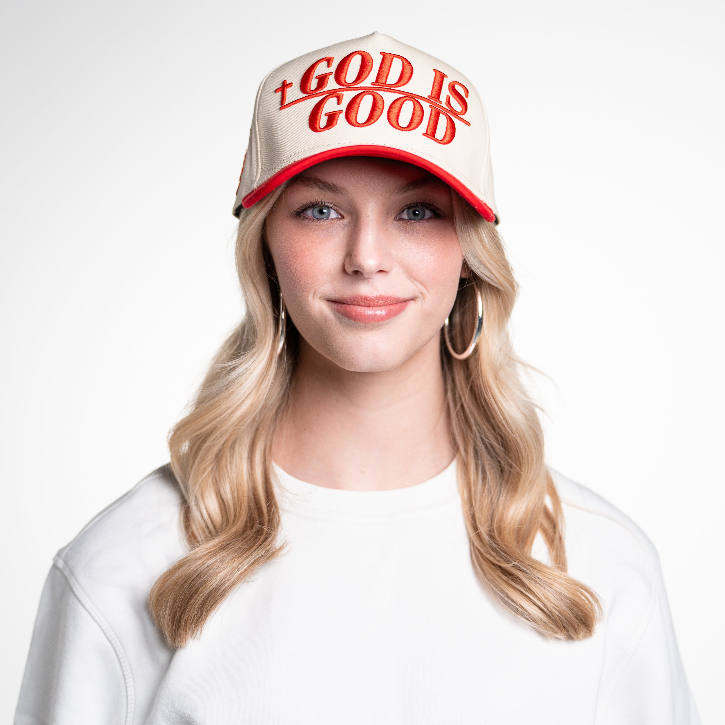 Woman wearing God Is Good Hat facing forward, showing full embroidered front and classic Christian streetwear style