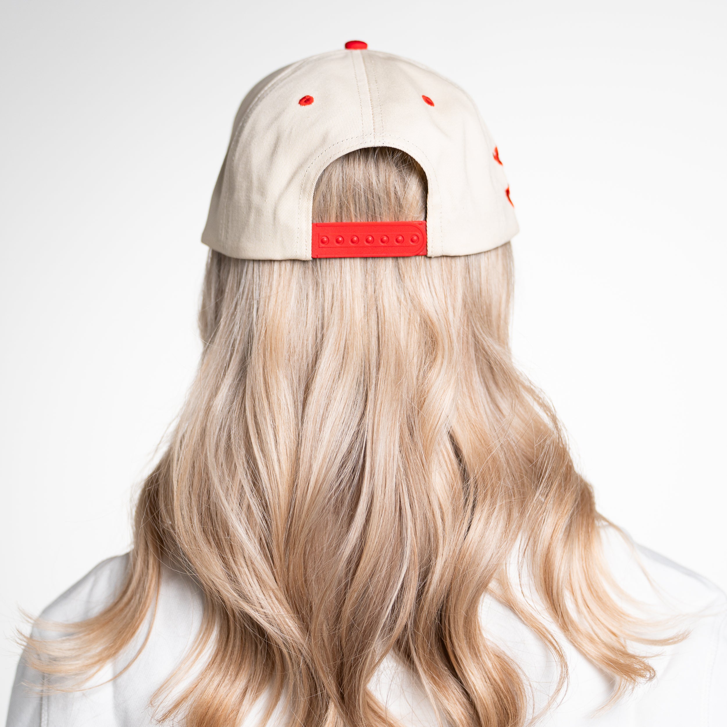 Back of God Is Good Hat worn by woman, displaying mesh trucker style and faith-based fashion details