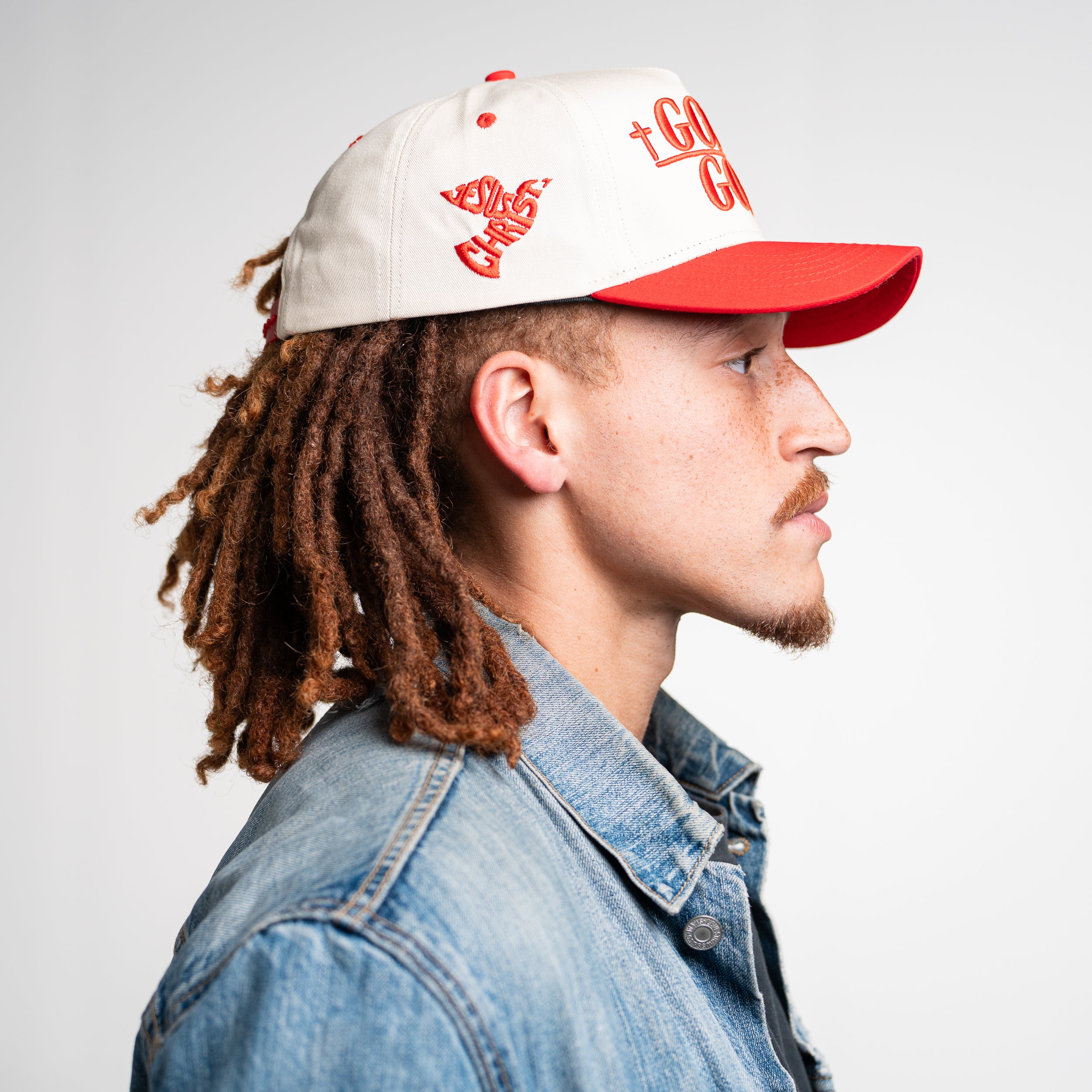 Right angle of man in God Is Good Hat, showing structured front and breathable mesh for everyday wear