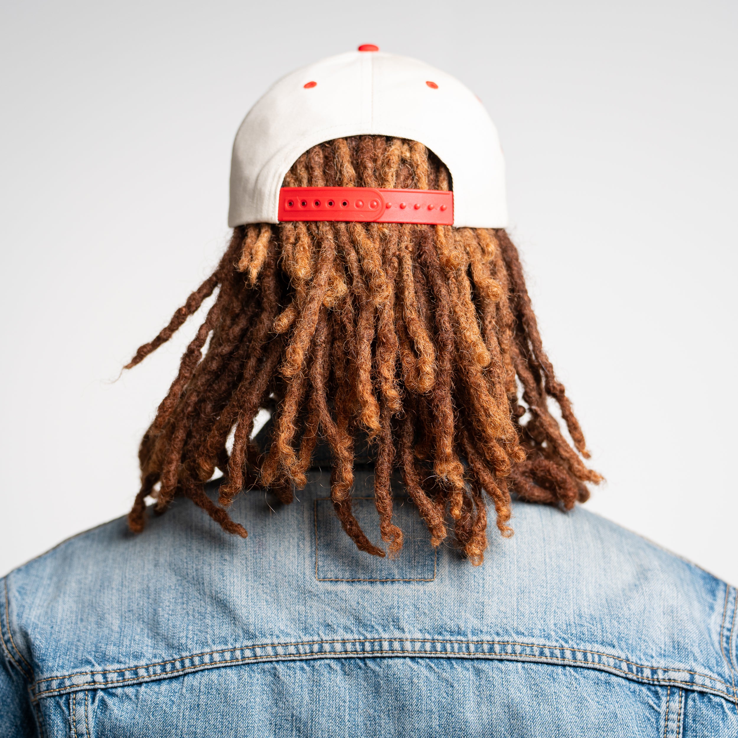 Rear view of man in God Is Good Hat, mesh snapback trucker cap designed for faith-forward lifestyle and comfort